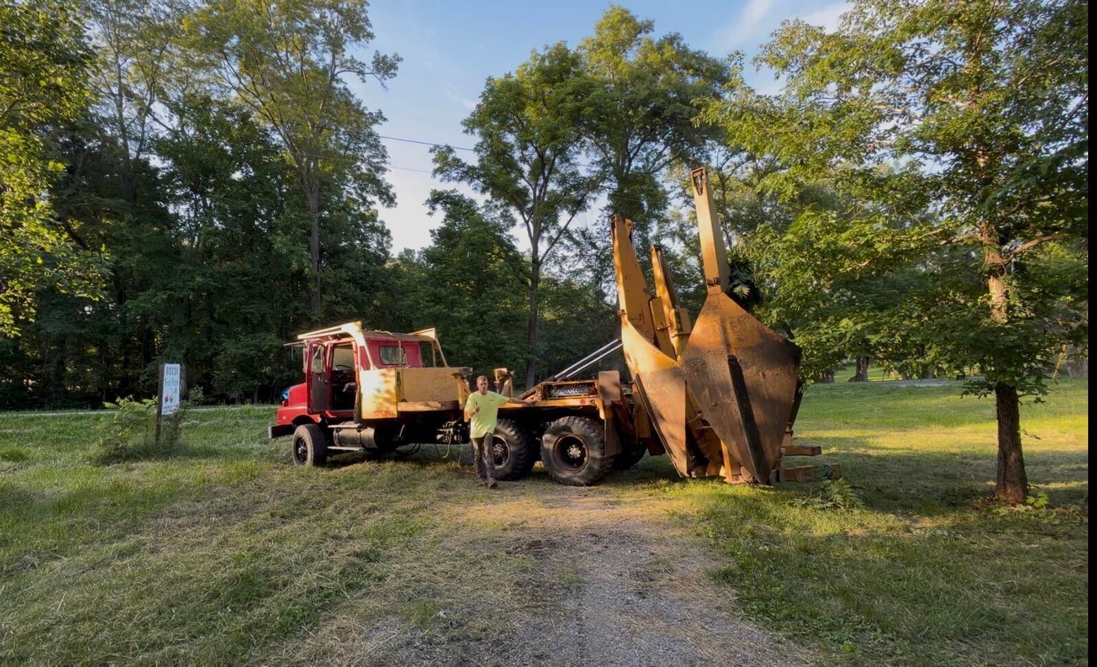 Tree spade truck digging up a tree for transplanting